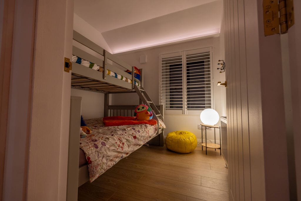 Bedroom with bunk bed in warm light in a 1950s terrace house