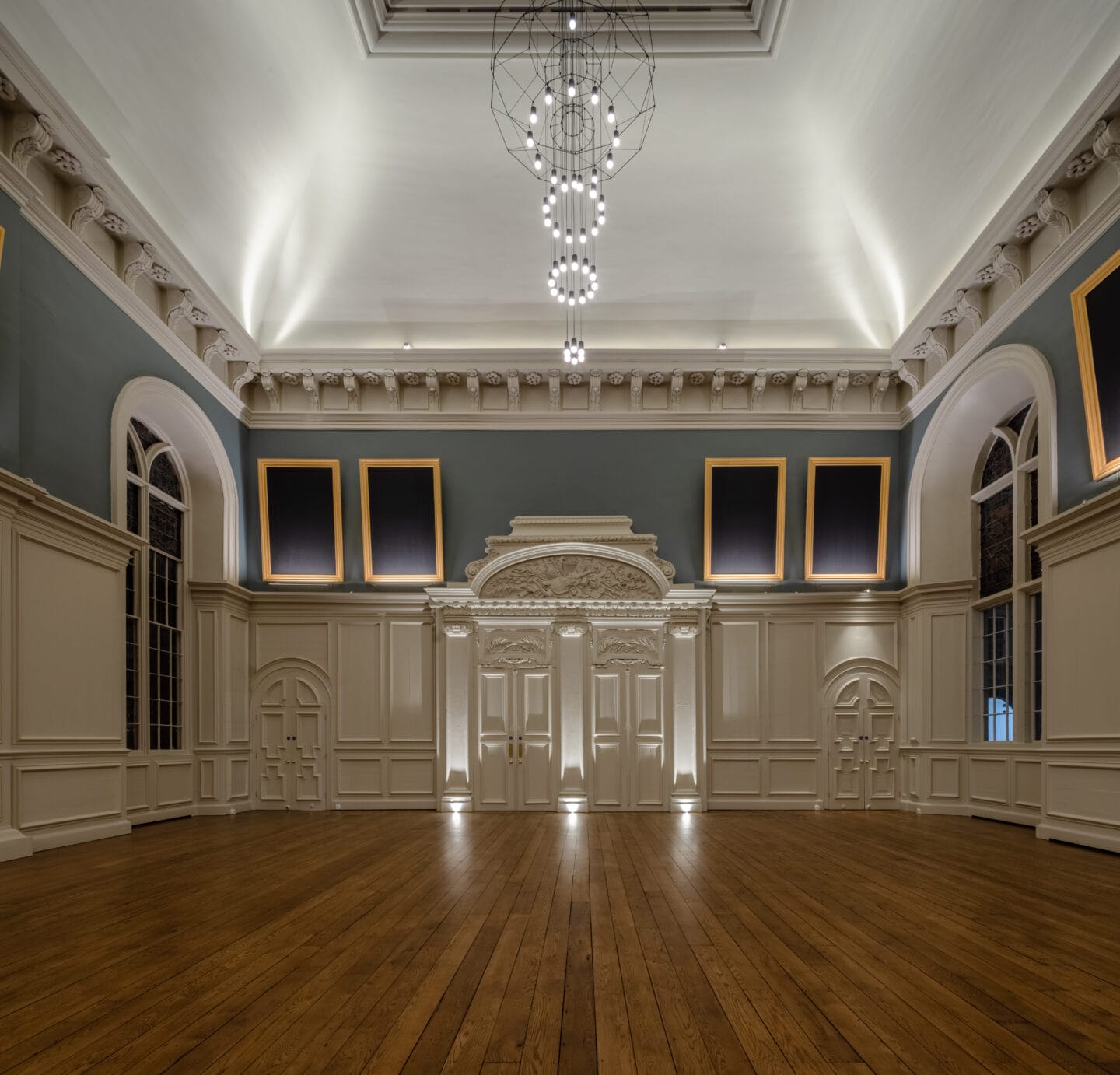 Royal Hospital Kilmainham's Great Hall with restored portraits and coved ceiling illuminated by bespoke lighting design